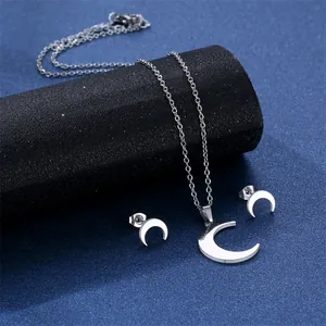Silver crescent moon stainless steel necklace and earrings jewelry set on starry background