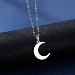 Polished stainless steel crescent moon pendant necklace set on a dark starry background