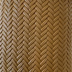 Macro detail of high-quality brown faux leather bucket bag with dense herringbone weave