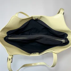 Internal view of cream tote bag with black lining, zipper divider and magnetic closure