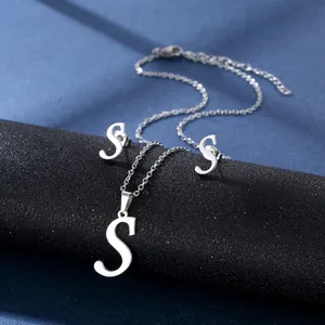 Poliertes Schmuckset aus silbernem Edelstahl mit S-Buchstaben-Anhänger auf schwarzem Ständer