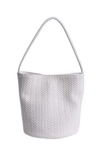 Minimalist white woven bucket bag with elegant leather texture and top handle