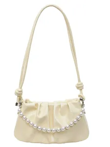 Chic ruched cream shoulder bag with elegant pearl chain and glossy leather finish