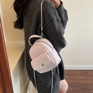 Detail of light pink mini rhinestone backpack with diamond quilting and chain strap