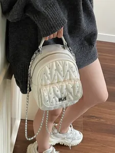 White quilted rhinestone mini backpack with metal chain straps and turn-lock pocket