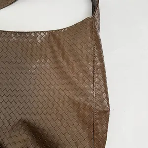 Detail of premium brown woven leather texture on this minimalist large hobo tote bag