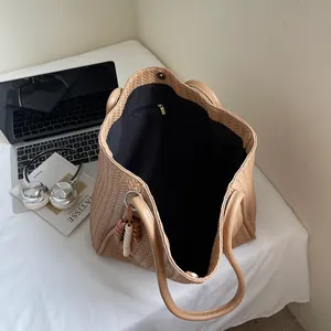 Top view of large woven tote bag with wooden bead charm and smooth double handles