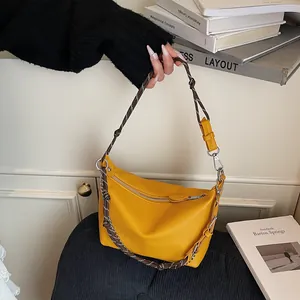 Detail of yellow lychee pattern bag with braided rope and silver chain strap
