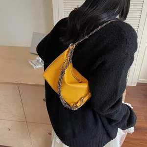 Yellow pebble leather underarm bag with unique braided rope and silver chain strap