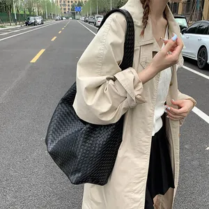 Detail view of black woven tote bag with premium cross-weave texture and matte finish