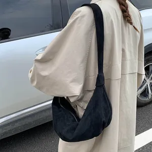 Detailed view of black matte hobo bag with a crescent shape and smooth zipper closure