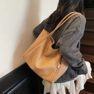 Detail of vintage large capacity woven tote bag with wooden bead tassels for commuting