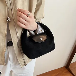 Minimalist black dumpling handbag with suede texture and leather flap for women