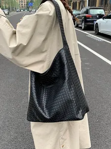 Minimalist black woven hobo shoulder bag with large capacity for daily commuting wear
