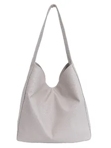 Minimalist light grey woven leather tote bag with a spacious interior for commute