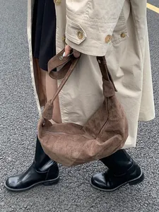 Brown suede hobo bag with large capacity and knot shoulder strap detail in autumn style