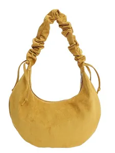 Mustard yellow suede dumpling bag with pleated drawstring shoulder strap design