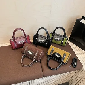 Chic multi-color cylinder handbags in smooth and suede textures with metallic heart lock
