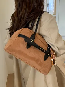 Vintage brown suede shoulder bag with black leather trim and bohemian beaded charm