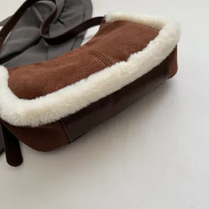 Detail of suede shoulder bag with soft faux fur trim and reinforced leather base