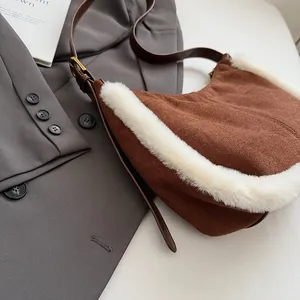 Detail of suede hobo bag with white faux fur trim and adjustable leather strap
