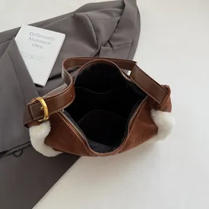 Interior view of suede shoulder bag showing large capacity and black inner pocket