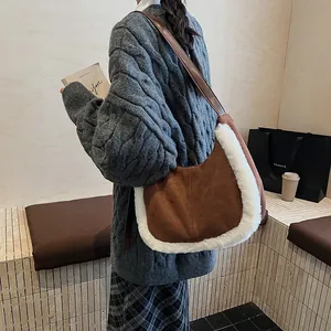 Detail of suede crescent bag with faux fur trim shown on a model in autumn outfit