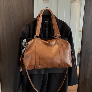 Close-up of brown PU leather tote bag with drawstrings on a black wool coat