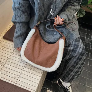 Detailed close-up of brown suede hobo bag with white faux fur trim and leather strap