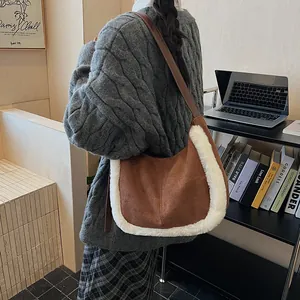 Detailed texture of brown suede shoulder bag with white faux fur trim and leather strap