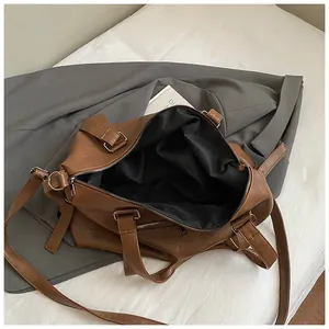 Detailed interior of a large brown travel tote showing spacious lining and zipper
