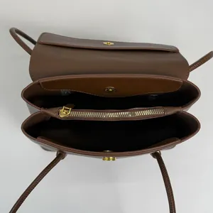 Brown lychee leather tote bag with three compartments and golden hardware seen from above