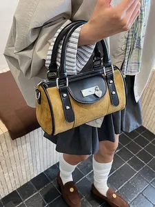 Retro mustard yellow barrel handbag with black leather handles and heart padlock detail