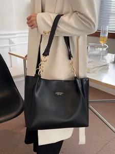 Stylish black leather tote bag with gold chain strap for school and daily commute