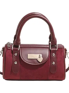 Burgundy Boston handbag with faux leather and suede patchwork and heart pendant