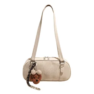 Chic beige underarm bowling bag with plush bear charm and sleek silver zipper closure