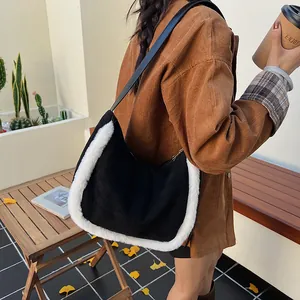 Detail of hobo shoulder bag in black wool and white faux fur on a model in autumn setting