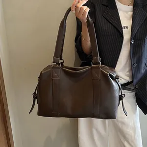 Detail of dark brown matte PU leather travel tote bag with reinforced handles