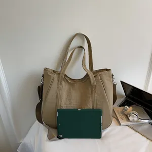 Large capacity nylon tote showing a green tablet inside for size reference
