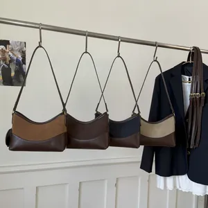 Retro suede crescent shoulder bag in four colors hanging in a stylish closet setting