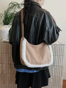 Beige suede shoulder bag with white faux fur trim styled with a winter leather jacket