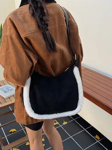 Suede contrast shoulder bag with white faux fur trim and adjustable leather strap