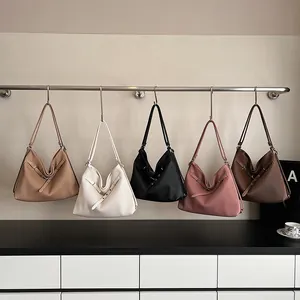 Close-up of pleated leather shoulder bags in five colors with decorative buckle details