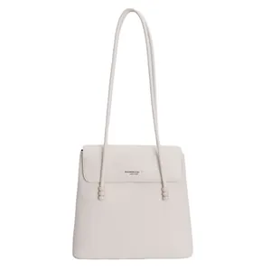 Minimalist cream white leather tote bag with long straps and decorative beads
