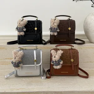 Détail de quatre sacs à dos à rabat léopard en noir, marron, argent et couleur caramel