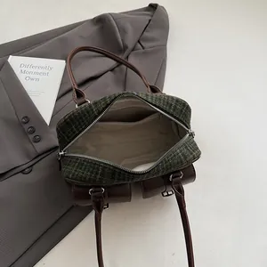 Detail view of the spacious inner compartment and lining of this vintage plaid Boston bag