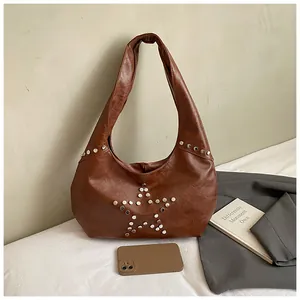 Detailed macro view of the brown PU leather hobo bag featuring silver star stud accents