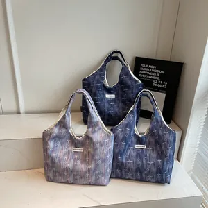 Detailed display of tote bags with starburst patterns and Kiss Yourself labels