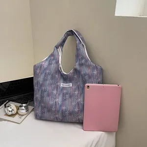 Chic star pattern tote bag shown next to a tablet to highlight its large capacity