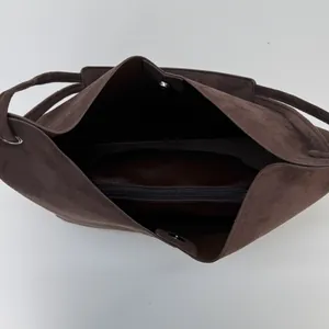 Vue macro de l'intérieur du sac cabas en daim marron foncé avec poche zippée et aimant